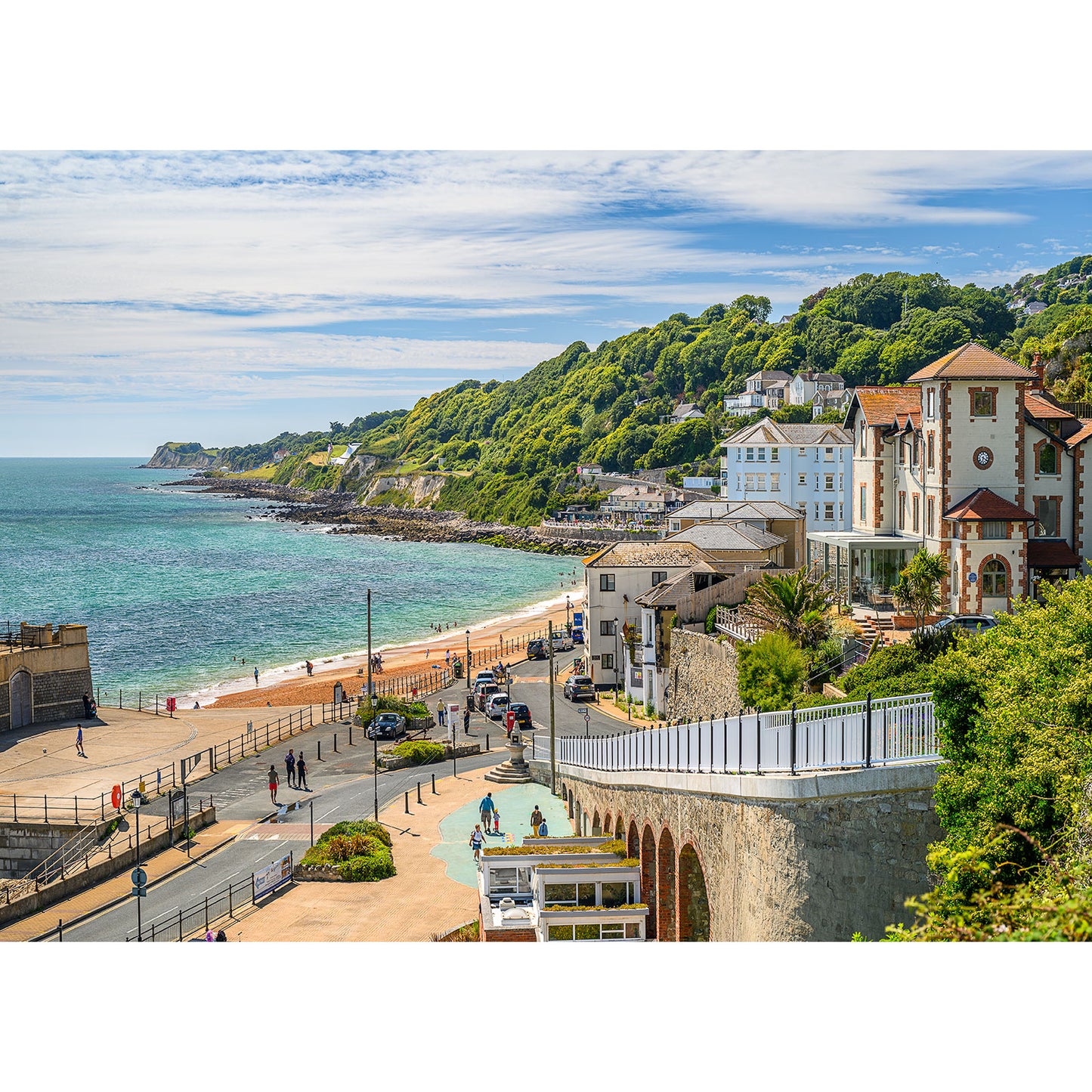 Image number: 2274, titled "Ventnor" by Available Light Photography, captures a coastal town with a scenic beach, promenade, and hillside buildings on a sunny day. People stroll along the promenade while the sea stretches into the distance.