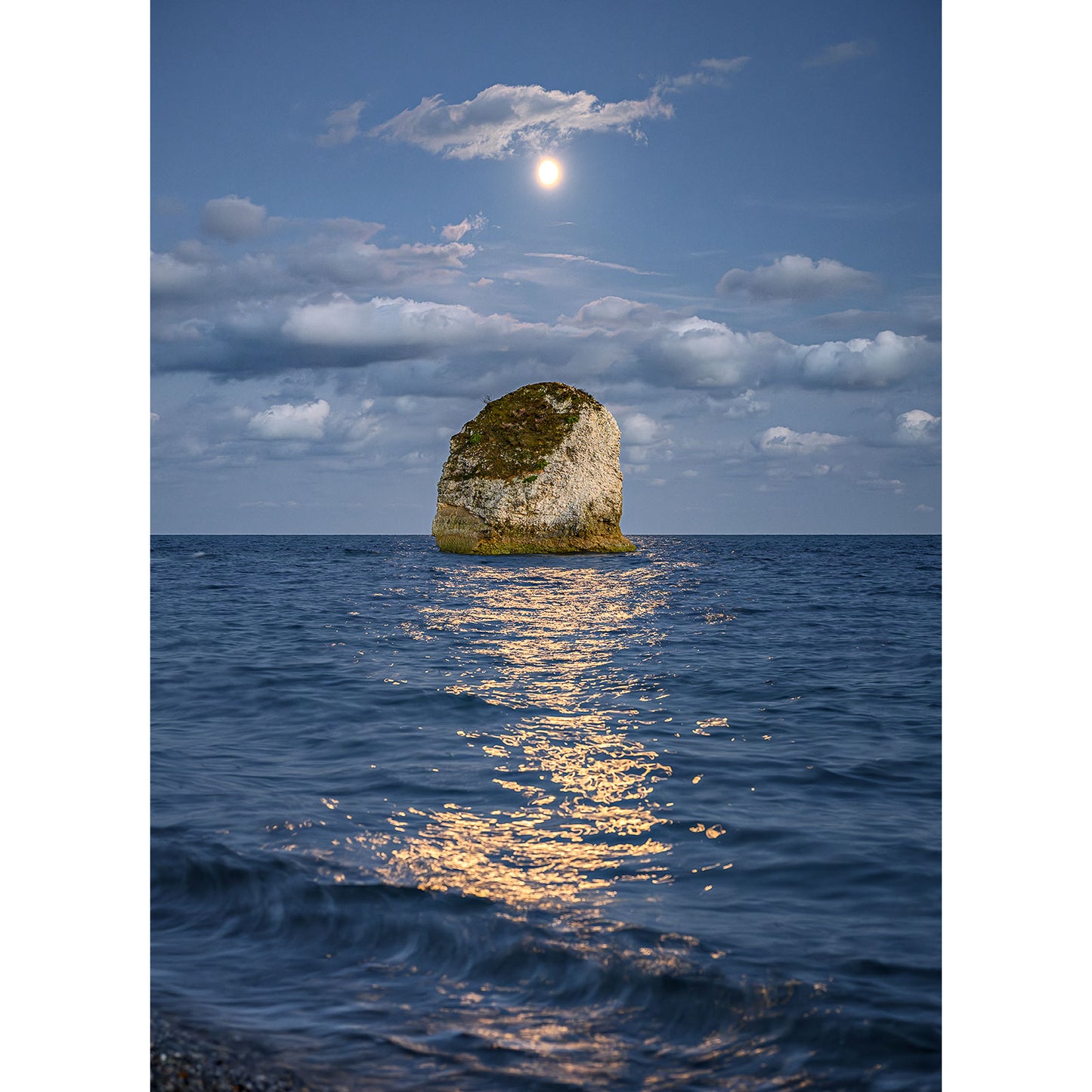 In the photograph titled "Moonlit Sea, Freshwater Bay" by Available Light Photography, a large rock formation juts out of calm ocean waters under a clear, moonlit sky with scattered clouds. The moonlight creates a glowing reflection on the water's surface in Image number 2904.