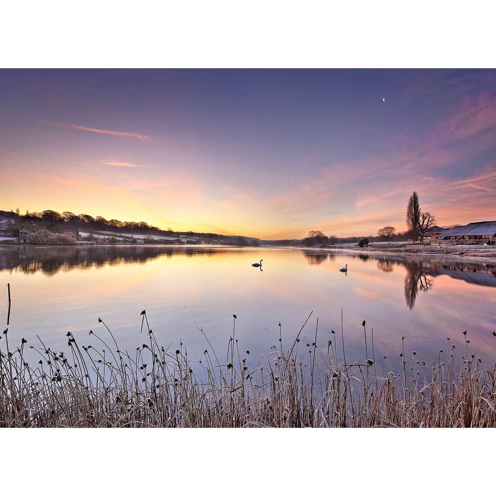 Tranquil dawn with The Old Mill Pond, Wootton Creek gliding on a mirror-like lake under a pastel-colored sky on the Isle by Available Light Photography.