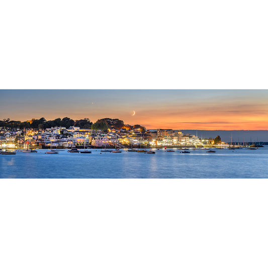 Coastal town illuminated at twilight with a Crescent Moon over Cowes hanging above the Isle of Wight, captured by Available Light Photography.