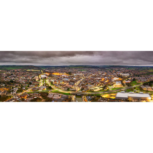 Aerial panoramic view of Newport, a sprawling town on the Isle of Wight at twilight with lights illuminating the streets and buildings under a cloudy sky taken by Available Light Photography.