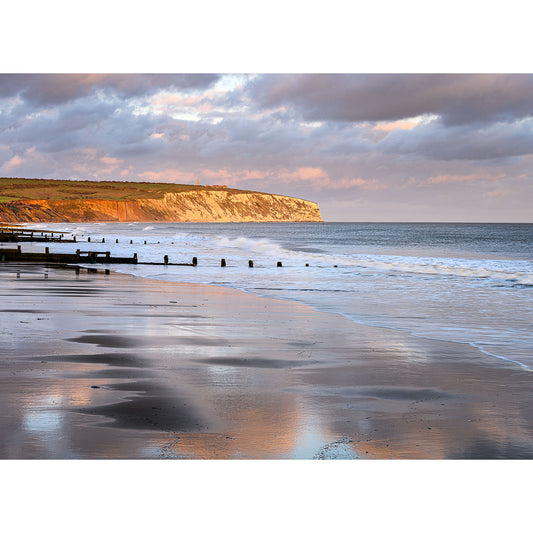 Sunset light reflecting on a serene beach with Culver Cliffs in the background, reminiscent of a scene Steve might capture by Available Light Photography.