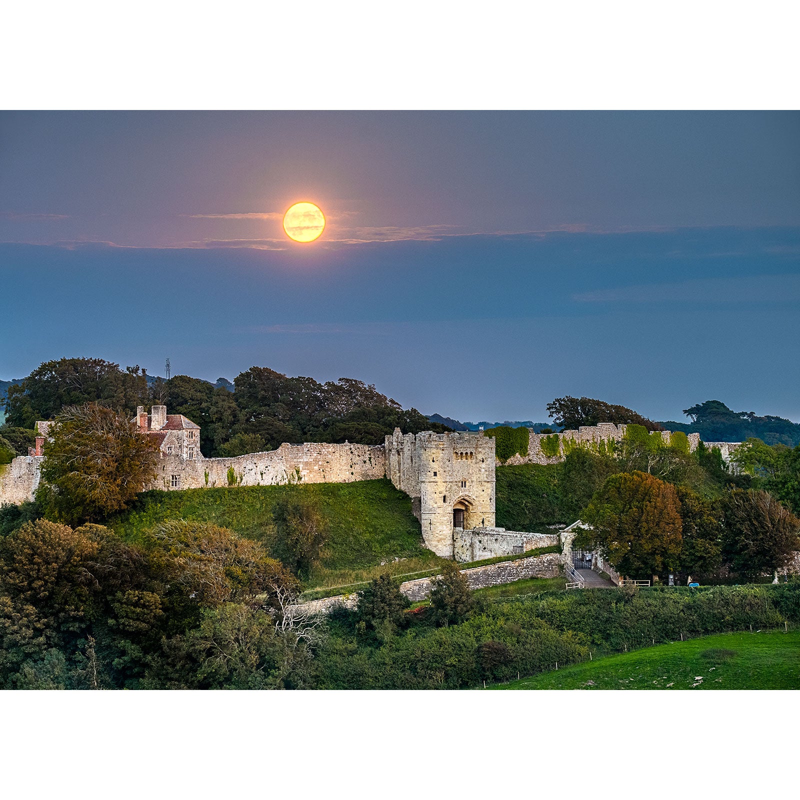 Full Moonrise rising over Carisbrooke Castle amidst a verdant landscape on the Isle of Wight, captured by Available Light Photography.