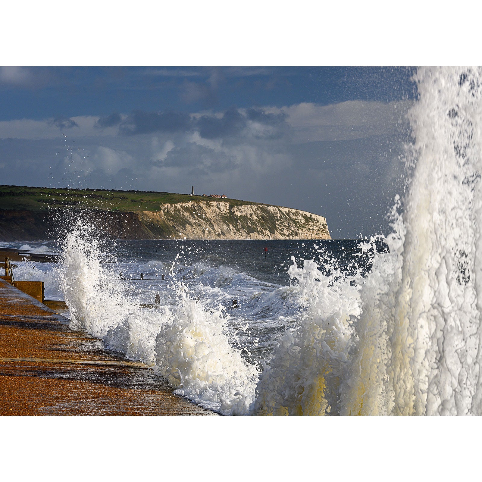 Stormy Seas crashing against the shore with a cliff in the background on the Isle of Wight, by Available Light Photography.