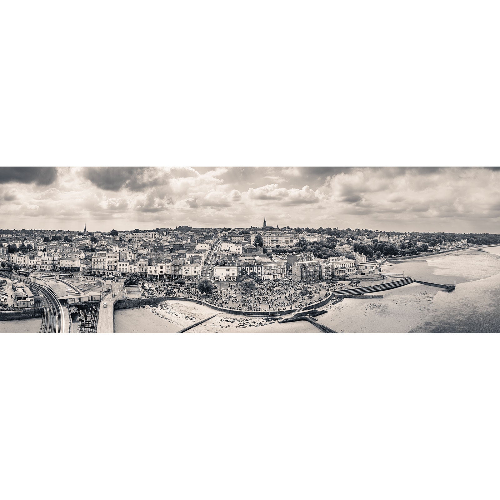 Panoramic view of a European cityscape by the river on an overcast day, capturing the essence of the Isle captured by Available Light Photography's Scooter Rally, Ryde.